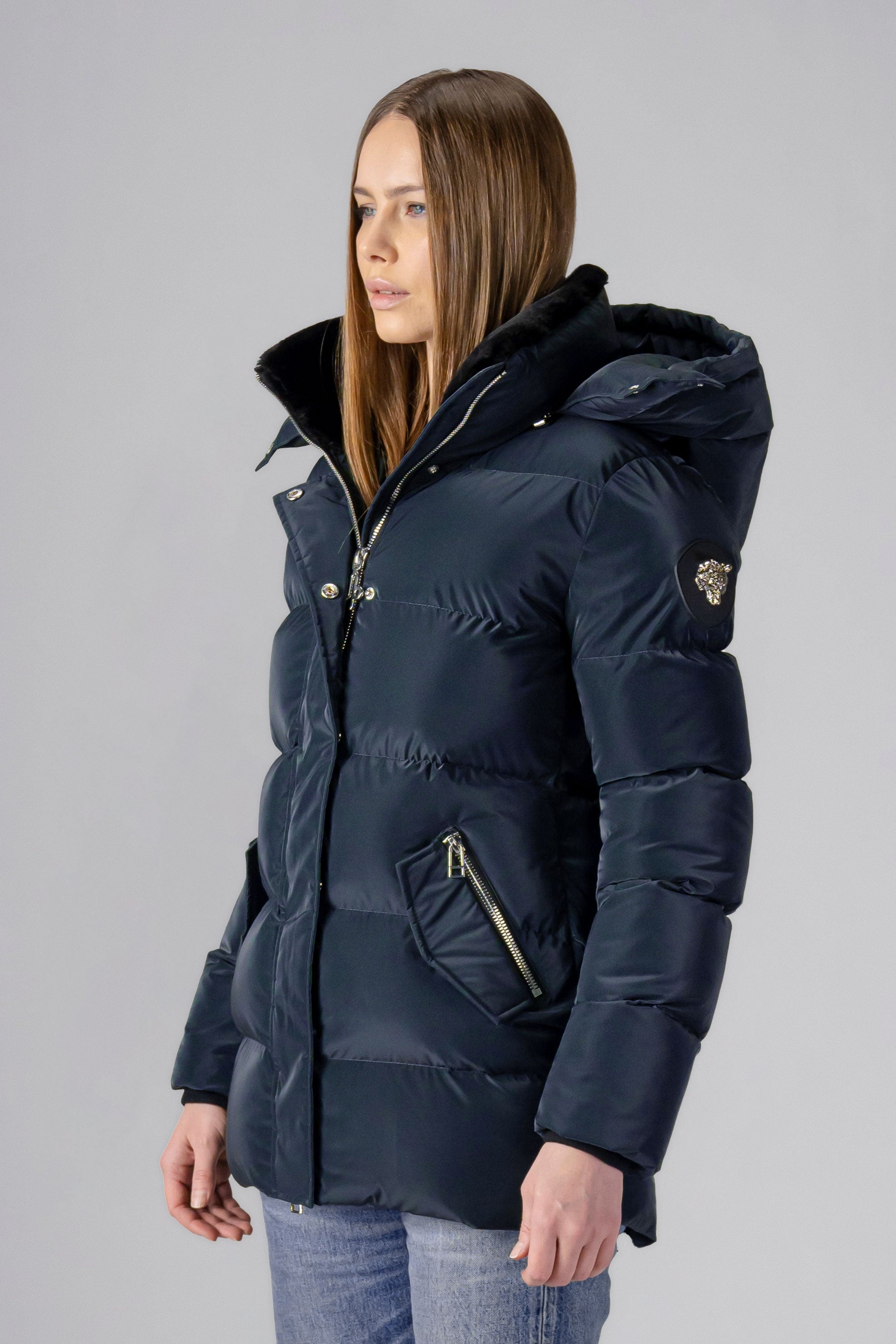 Woodpecker Women's Bumnester Winter coat. High-end Canadian designer winter coat for women in shiny "Blue Diamond" colour. Woodpecker cruelty-free winter coat designed in Canada. Women's heavy weight medium length premium designer jacket for winter. Superior quality warm winter coat for women. Moose Knuckles, Canada Goose, Mackage, Montcler, Will Poho, Willbird, Nic Bayley. Extra warm. Shiny parka. Stylish winter jacket. Designer winter coat.