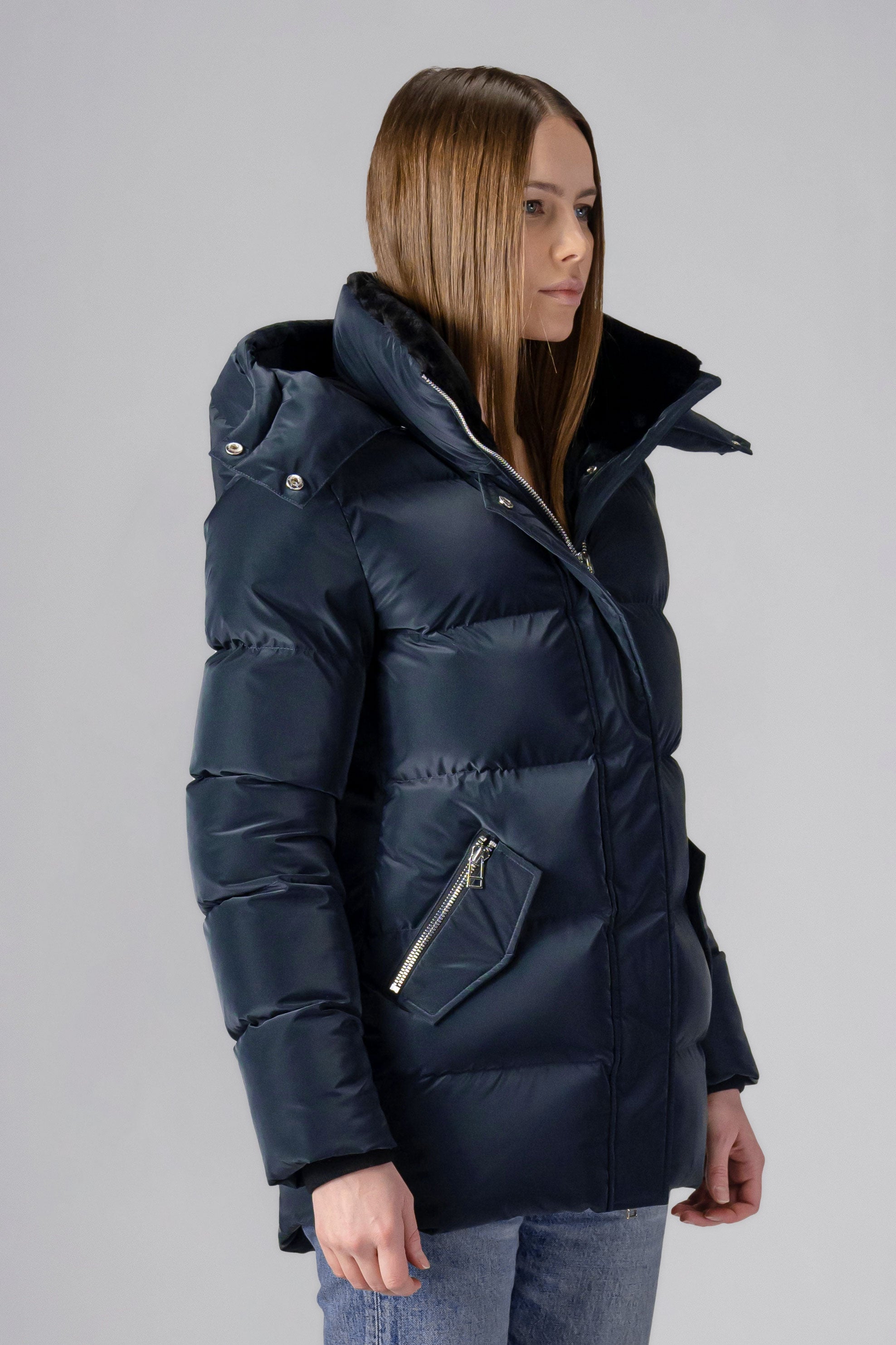 Woodpecker Women's Bumnester Winter coat. High-end Canadian designer winter coat for women in shiny "Blue Diamond" colour. Woodpecker cruelty-free winter coat designed in Canada. Women's heavy weight medium length premium designer jacket for winter. Superior quality warm winter coat for women. Moose Knuckles, Canada Goose, Mackage, Montcler, Will Poho, Willbird, Nic Bayley. Extra warm. Shiny parka. Stylish winter jacket. Designer winter coat.