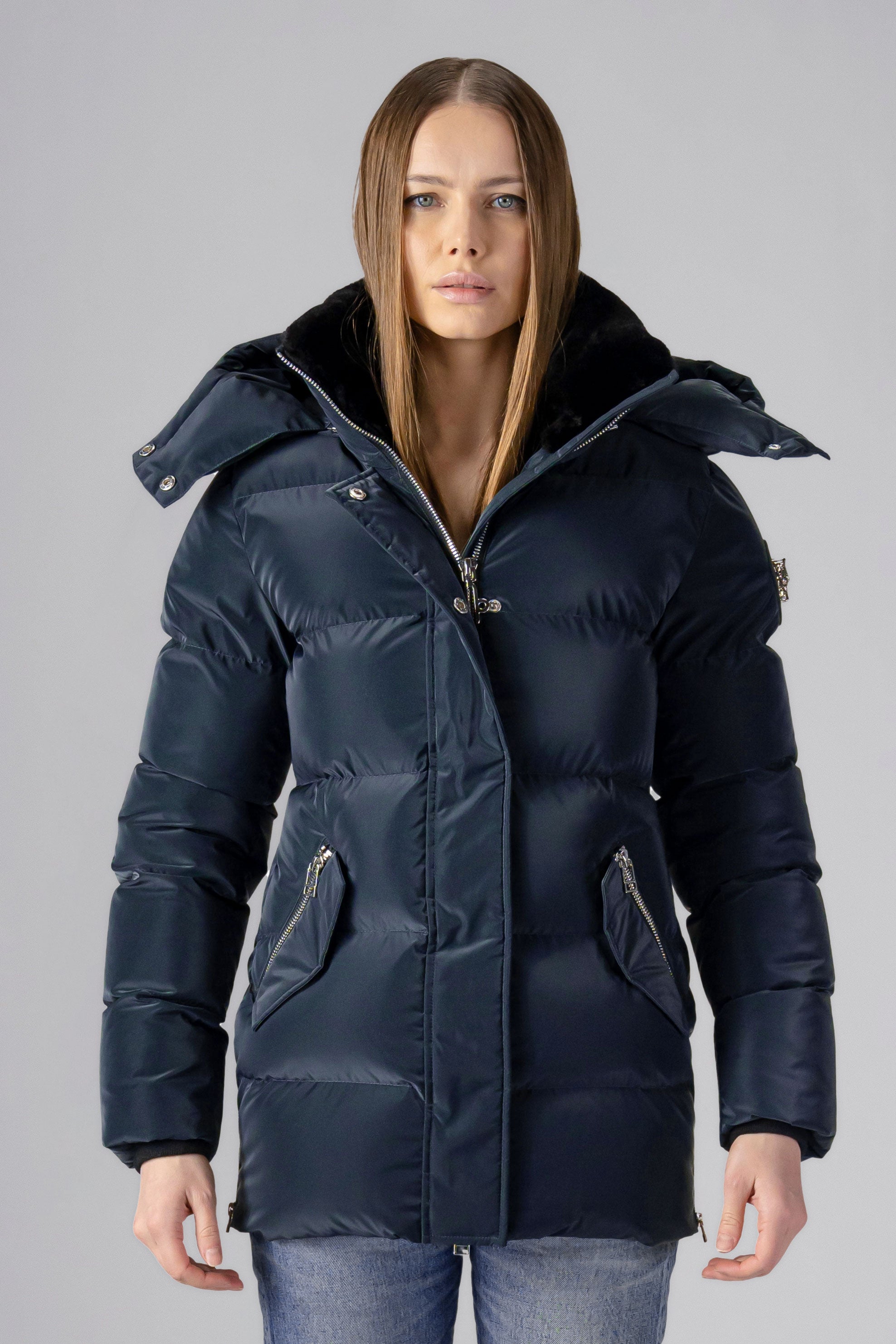 Woodpecker Women's Bumnester Winter coat. High-end Canadian designer winter coat for women in shiny "Blue Diamond" colour. Woodpecker cruelty-free winter coat designed in Canada. Women's heavy weight medium length premium designer jacket for winter. Superior quality warm winter coat for women. Moose Knuckles, Canada Goose, Mackage, Montcler, Will Poho, Willbird, Nic Bayley. Extra warm. Shiny parka. Stylish winter jacket. Designer winter coat.