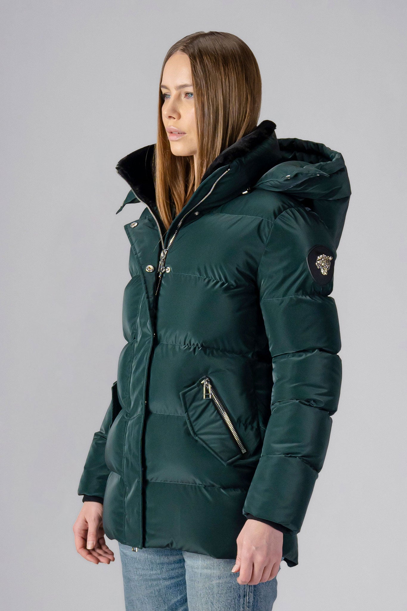 Woodpecker Women&#39;s Bumnester Winter coat. High-end Canadian designer winter coat for women in shiny &quot;Green Diamond&quot; colour. Woodpecker cruelty-free winter coat designed in Canada. Women&#39;s heavy weight medium length premium designer jacket for winter. Superior quality warm winter coat for women. Moose Knuckles, Canada Goose, Mackage, Montcler, Will Poho, Willbird, Nic Bayley. Extra warm. Shiny parka. Stylish winter jacket. Designer winter coat.