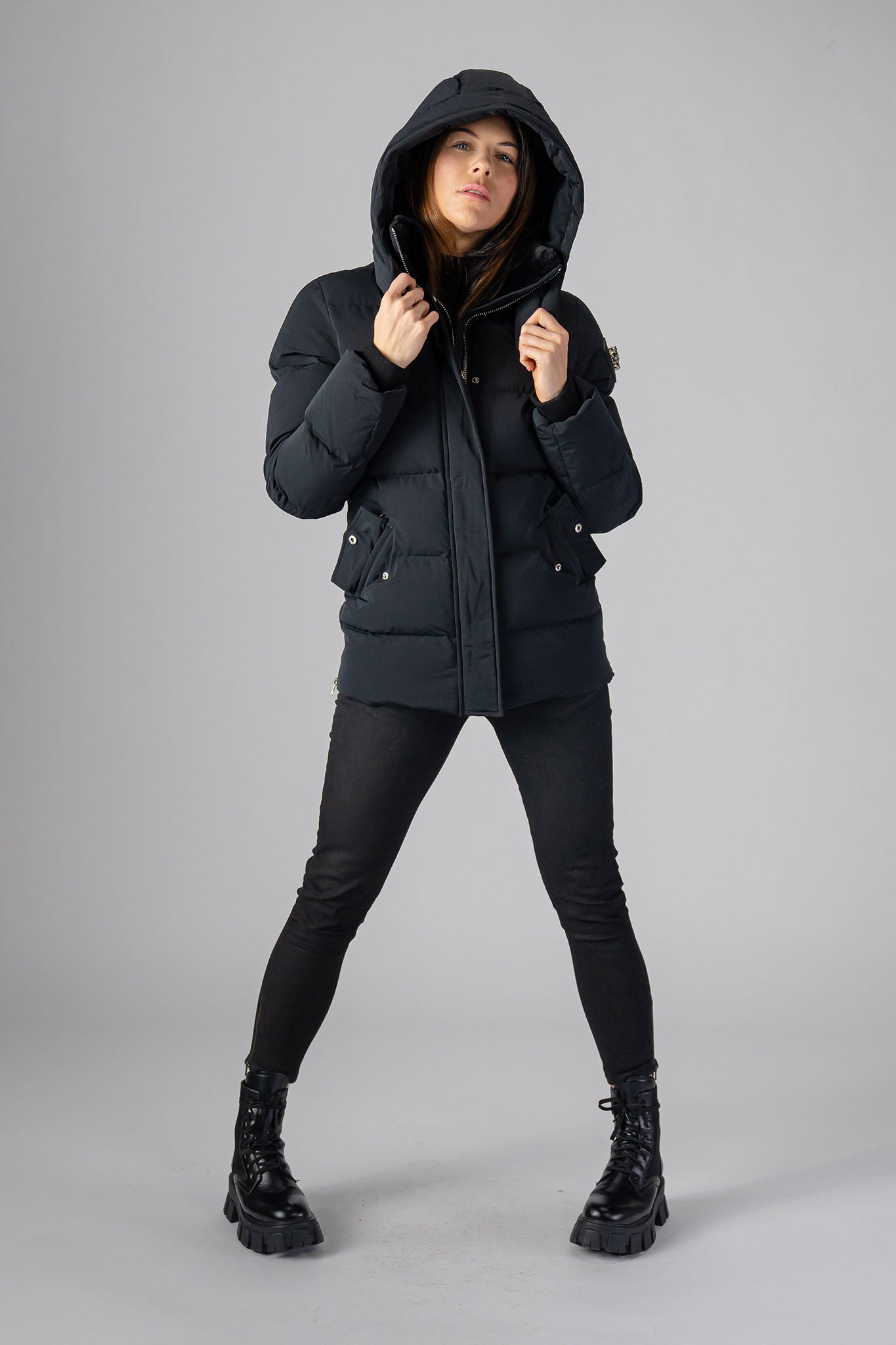 Woodpecker Women's Bumnester Winter coat. High-end Canadian designer winter coat for women in "Matte Black" colour. Woodpecker cruelty-free winter coat designed in Canada. Women's heavy weight medium length premium designer jacket for winter. Superior quality warm winter coat for women. Moose Knuckles, Canada Goose, Mackage, Montcler, Will Poho, Willbird, Nic Bayley. Extra warm. Shiny parka. Stylish winter jacket. Designer winter coat.