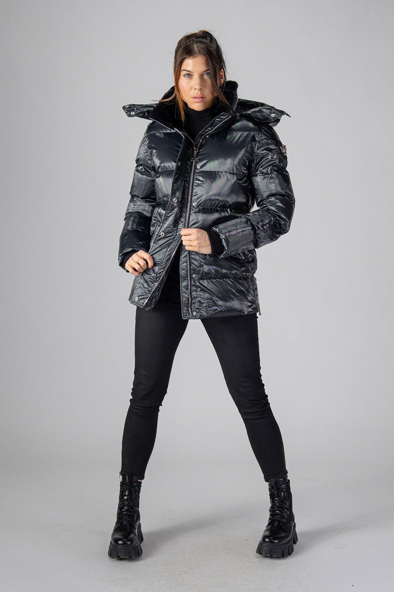 Woodpecker Women's Bumnester Winter coat. High-end Canadian designer winter coat for women in "Oily Black" colour. Woodpecker cruelty-free winter coat designed in Canada. Women's heavy weight medium length premium designer jacket for winter. Superior quality warm winter coat for women. Moose Knuckles, Canada Goose, Mackage, Montcler, Will Poho, Willbird, Nic Bayley. Extra warm. Shiny parka. Stylish winter jacket. Designer winter coat.