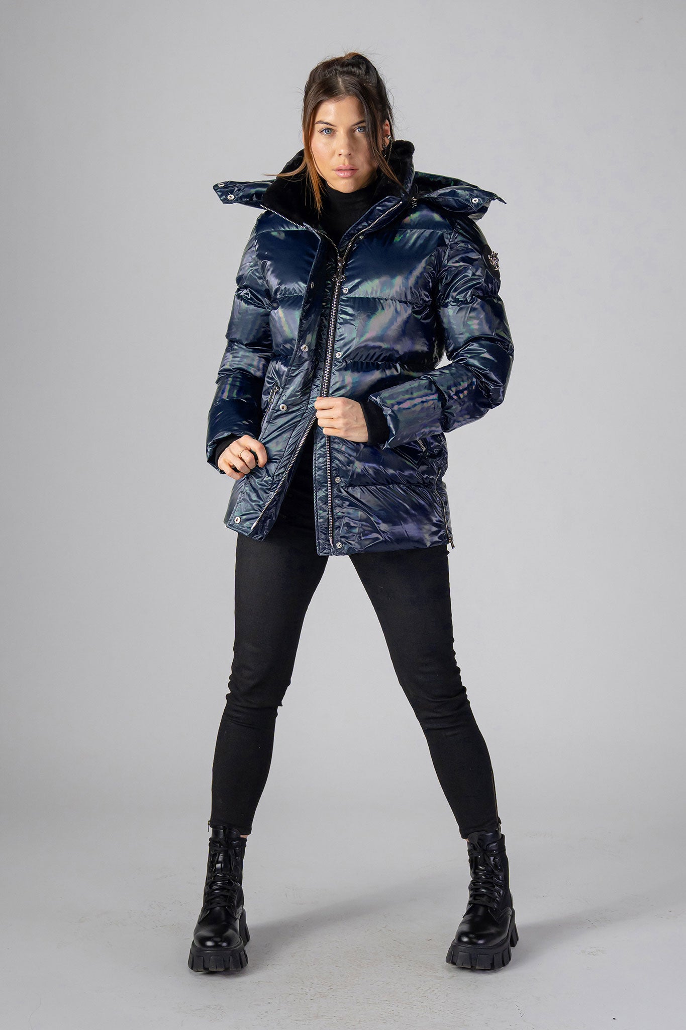 Woodpecker Women&#39;s Bumnester Winter coat. High-end Canadian designer winter coat for women in &quot;Oily Blue&quot; colour. Woodpecker cruelty-free winter coat designed in Canada. Women&#39;s heavy weight medium length premium designer jacket for winter. Superior quality warm winter coat for women. Moose Knuckles, Canada Goose, Mackage, Montcler, Will Poho, Willbird, Nic Bayley. Extra warm. Shiny parka. Stylish winter jacket. Designer winter coat.