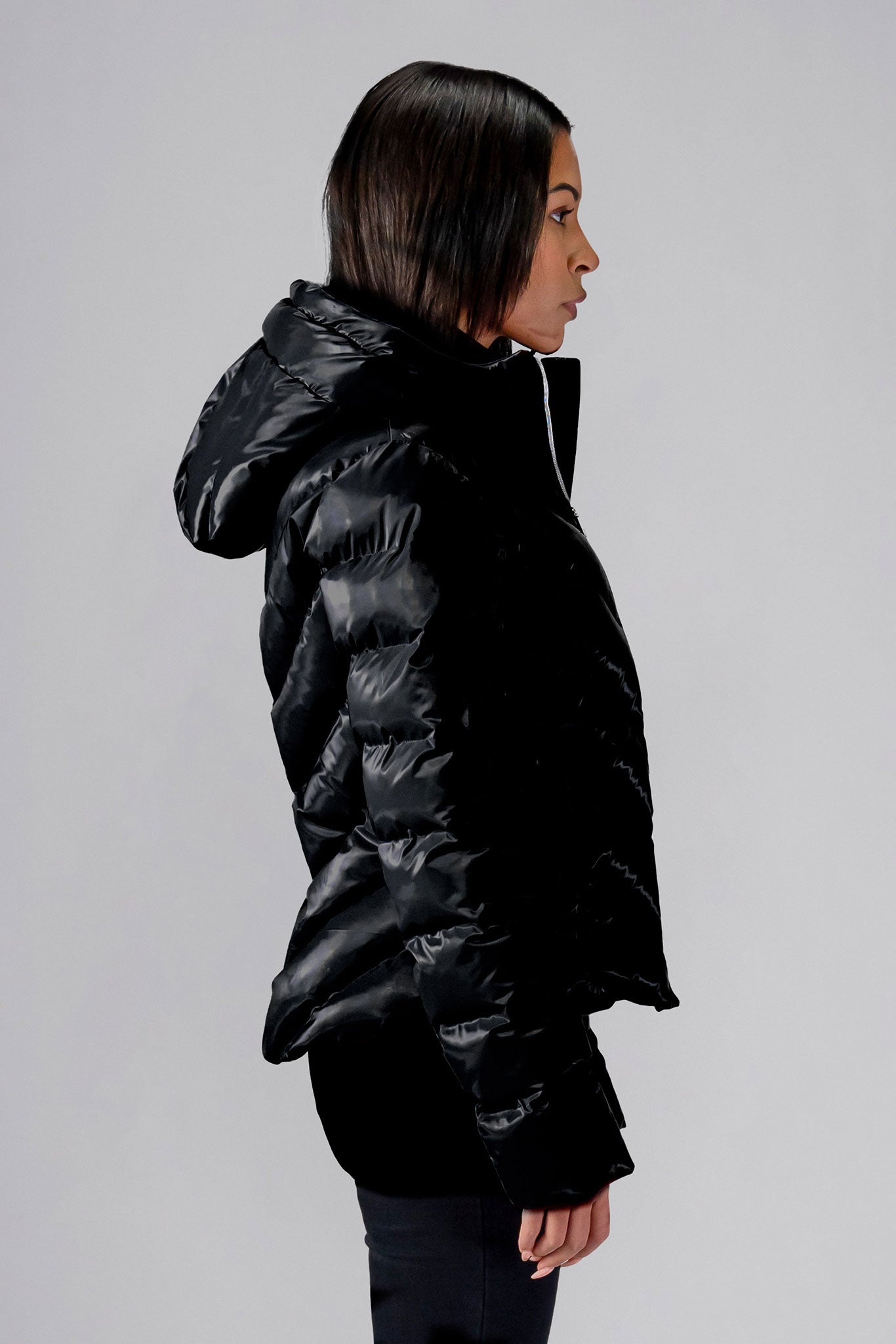 Woodpecker Women's Robin Winter coat. High-end Canadian designer winter coat for women in "All Wet Black" colour. Woodpecker cruelty-free winter coat designed in Canada. Women's medium weight medium length premium designer jacket for winter. Superior quality warm winter coat for women. Moose Knuckles, Canada Goose, Mackage, Montcler, Will Poho, Willbird, Nic Bayley. Extra warm. Shiny parka. Stylish winter jacket. Designer winter coat.